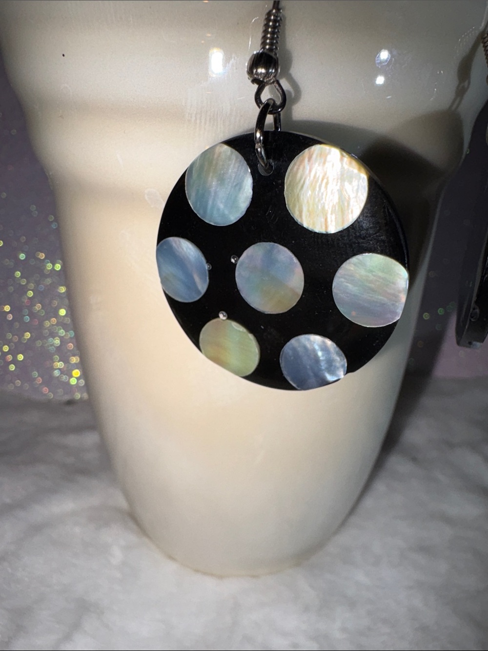 Mother of pearl polka dots embedded  on polished black horn from Indonesia.